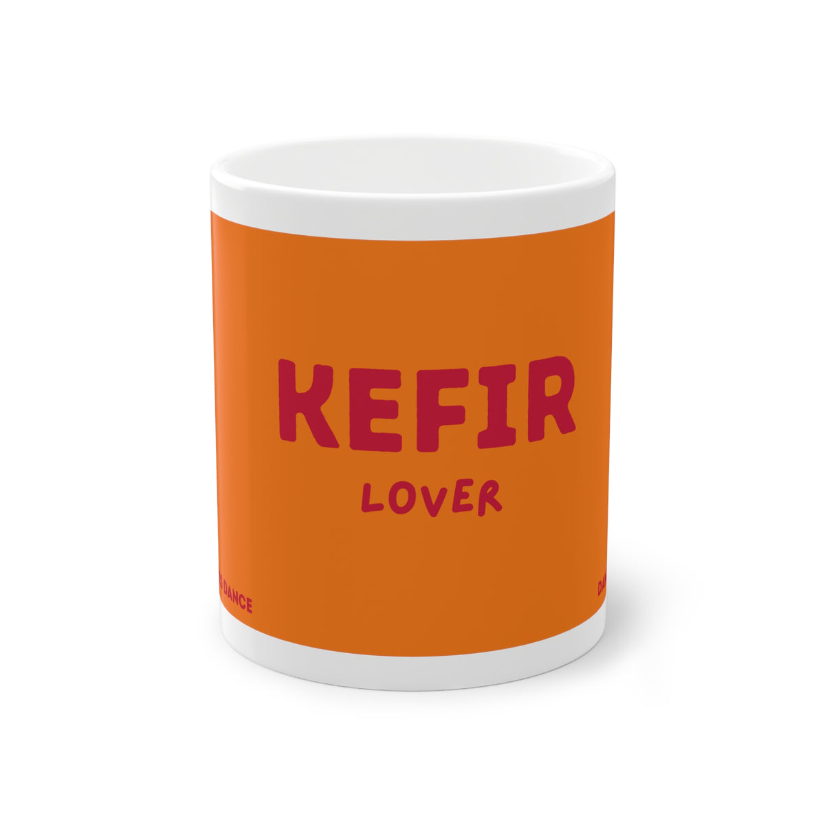 Orangefarbene Kefir Lover Keramiktasse von Dancing Microbes mit dunkelrosa Schriftzug „KEFIR LOVER“ auf weißem Hintergrund.