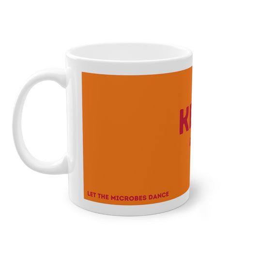 Orangefarbene Kefir Lover Tasse mit weißem Henkel auf der linken Seite und teilweise sichtbarem Aufdruck.